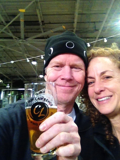 Brian and Lisa toasting at Captain Lawrence Brewery — Brian wearing the Moon Hat