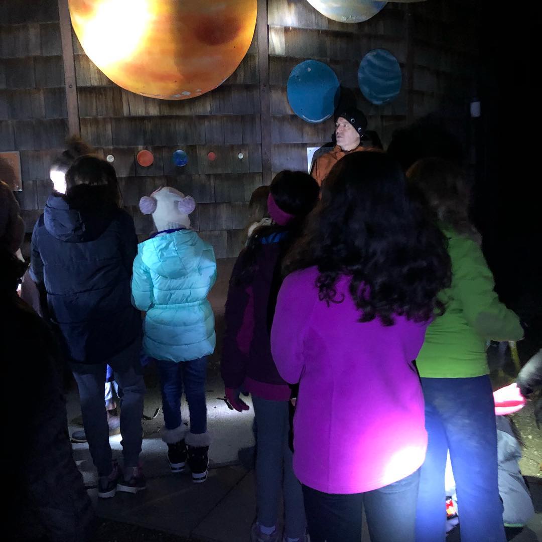 Daniel Cummings wearing Moon Hat at Sharpe Reservation planetarium with Girl Scout troop at night