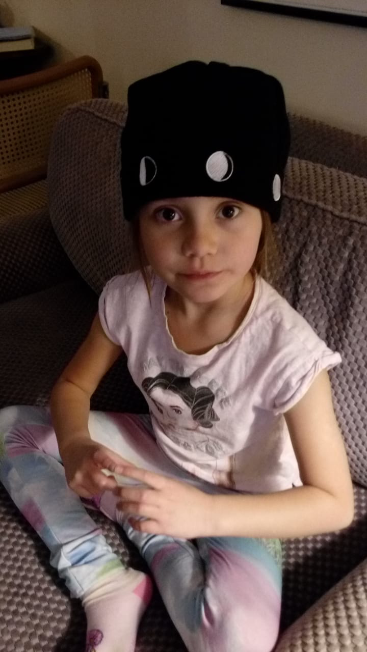 Girl sitting on couch wearing the Moon Hat