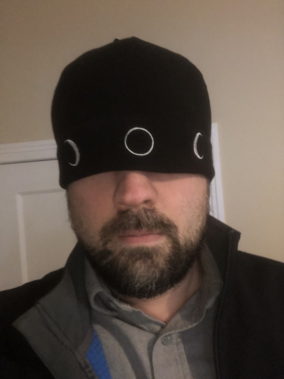 Man with beard wearing Moon Hat pulled over eyes