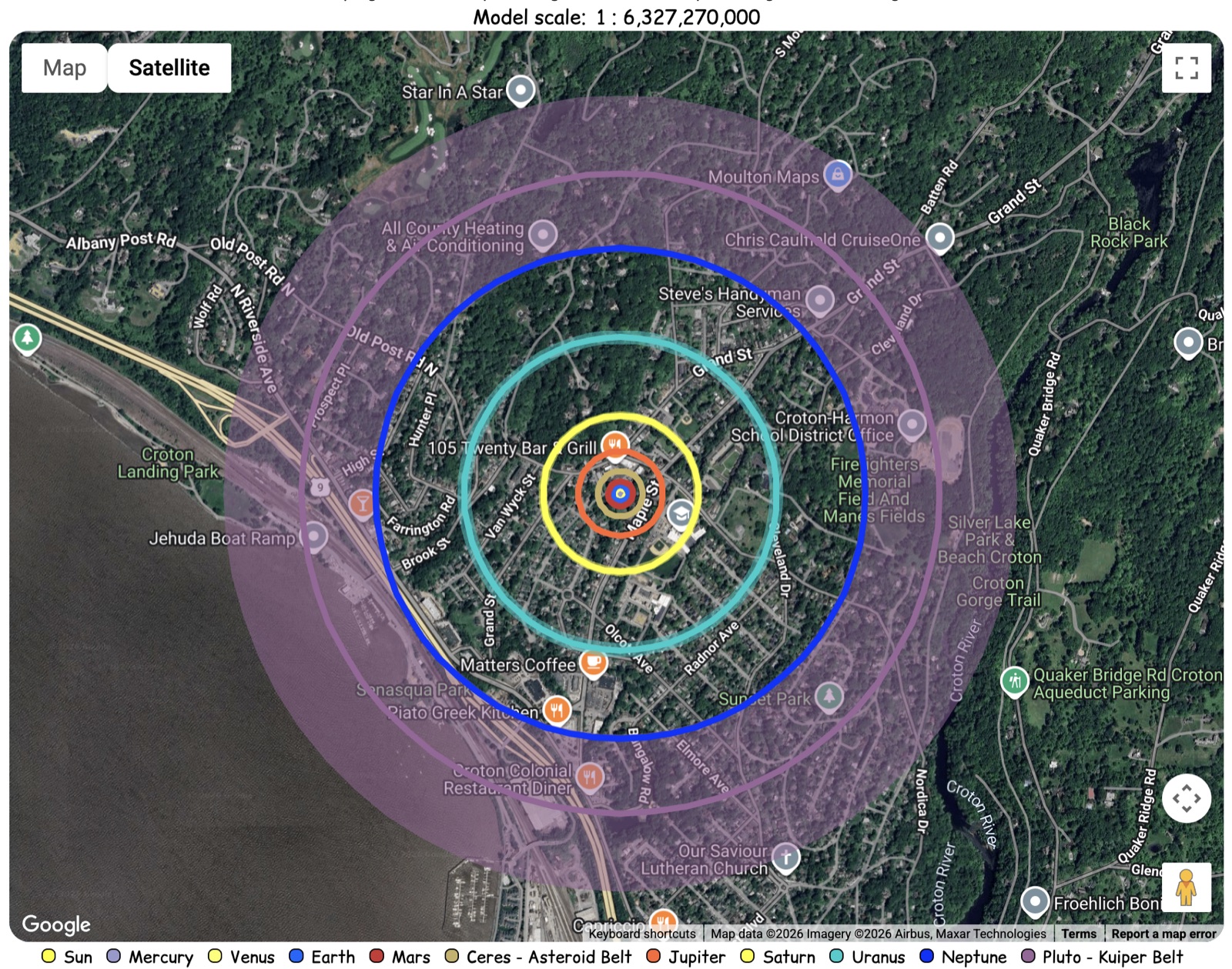 All planetary orbit rings out to Pluto drawn over Croton-on-Hudson, reaching the Hudson River